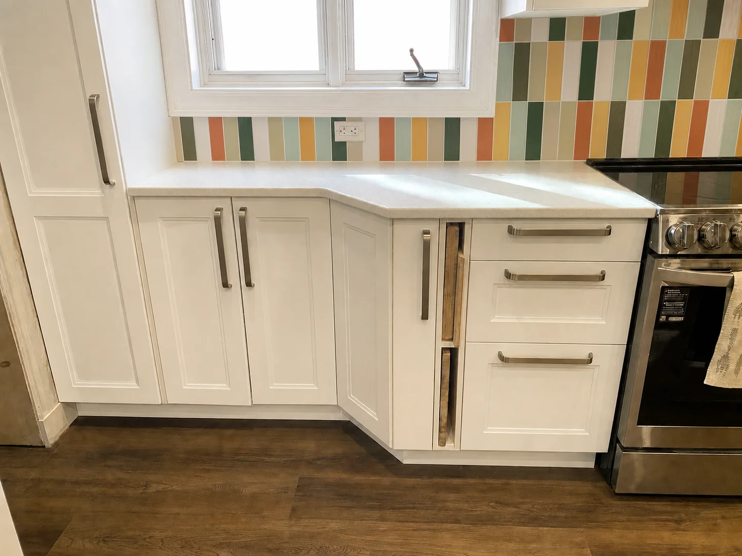 IKEA kitchen with a custom 45-degree corner cabinet and open cutting-board cabinet